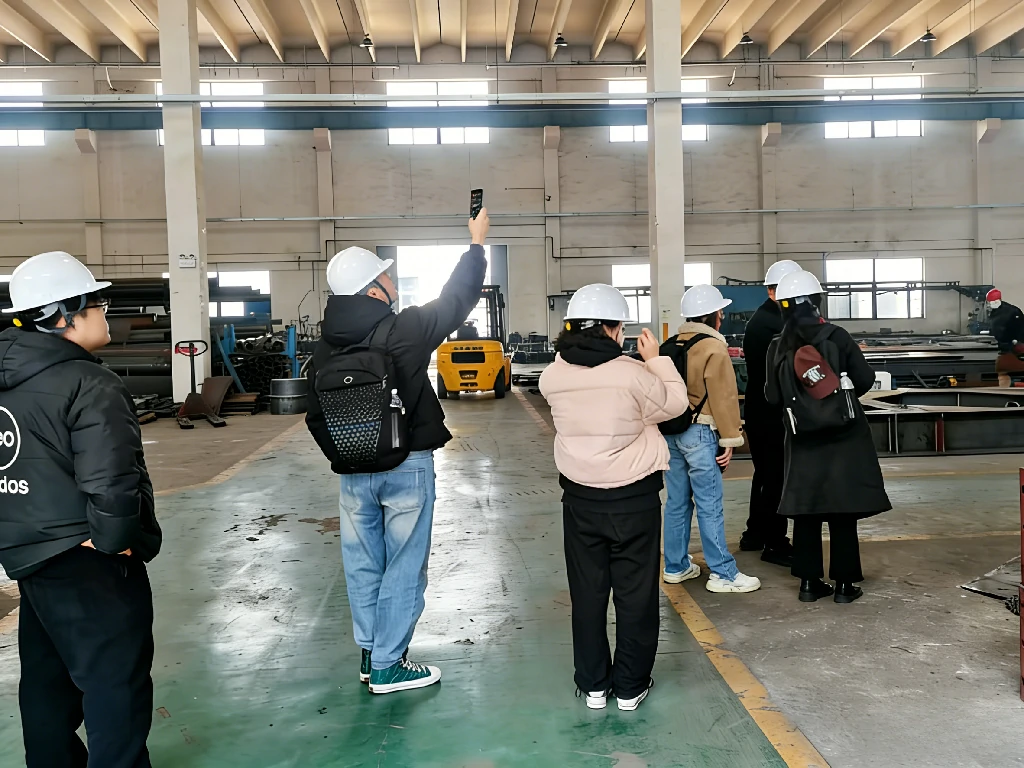 International clients inspecting the heavy-duty quarry rock crusher assembly line at our factory.